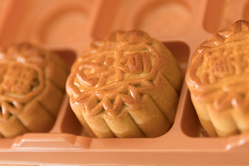 Traditional pastry mooncakes is offered to friends or family during Mid-Autumn Festival. Flatlay table top view dark light with copy space. The Chinese character represent 