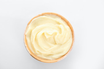 Bowl with tasty mashed potatoes on white background, top view