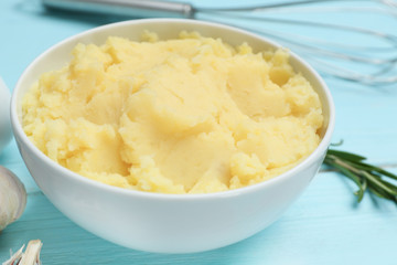 Bowl with mashed potatoes on wooden table