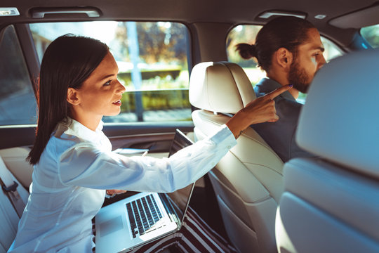 Chauffeur Driven Limousine With The Business Woman In The Back Seat