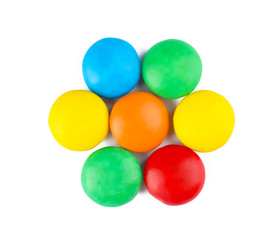 Tasty colorful candies on white background, top view