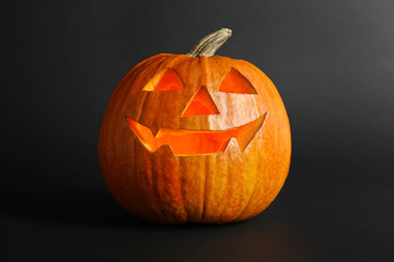 Fototapeta premium Halloween pumpkin head jack lantern on dark background