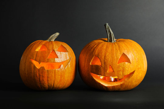 Halloween pumpkin head jack lanterns on dark background