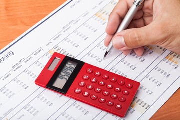 Close-up of a Businessman Analyzing Financial Figures with