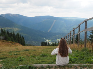 Young girl, teenager on the background of the Giant Mountains, view from the top Medwiedin, Western Sudetes