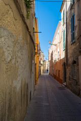 Naklejka na ściany i meble Deserted alley in a italian old city