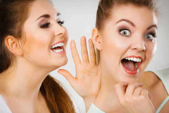 Two women telling gossip