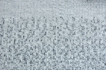 warm gray light dark gradient woolen sweater fabric texture background wool close-up.