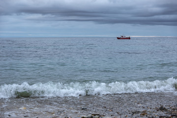 fishing boat fishing along the coast on a stormy day
