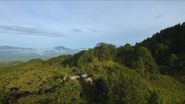 An aerial view of the top of a mountain with a small house at Honduras, Central America