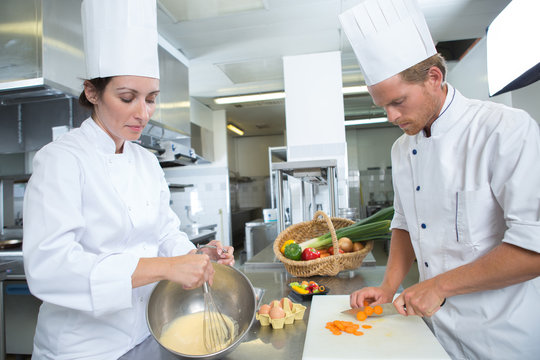 male and female chef working at kitchen