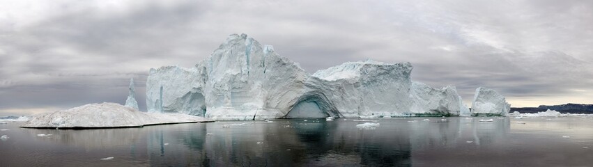 Iceberg floating in the water off the coast of Greenland. Nature and landscapes of Greenland. © Uryadnikov Sergey