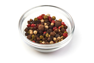 Pepper mix. Black, red and white peppercorns in a transparent cup, isolated on white background. Close-up