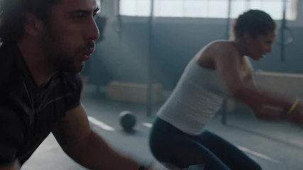 fitness athletes training intense workout using battle ropes team exercise challenge in gym friends high five enjoying healthy bodybuilding lifestyle together