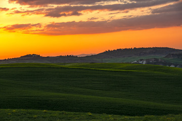 Landscape of tuscan countryside at sunset