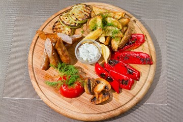 smoked sausages with grilled tomatoes, paprika, mushrooms, zucchini, fried potatoes, dill, white sour sauce, tasty flatlay food photo