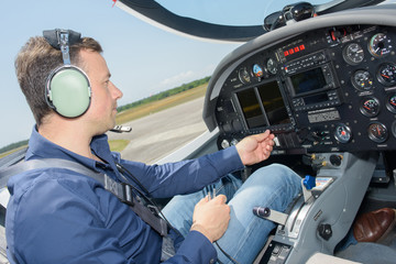 Pilot operating cockpit controls © auremar