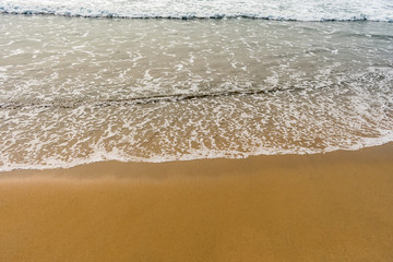 A beautiful pattern of sea water with foam created  after collide sea water wave at sea shore.