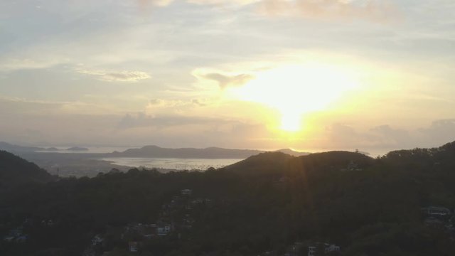 aerial view sunrise in Chalong sea Phuket big Buddha is on the top of Nakkerd mountain.