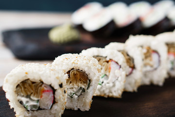 Restaurant menu, Japanese traditional food. Appetizing sushi rolls served on wooden trays