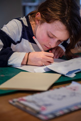 girl writing on envelope