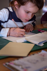 Fototapeta na wymiar young girl copying address onto envelope