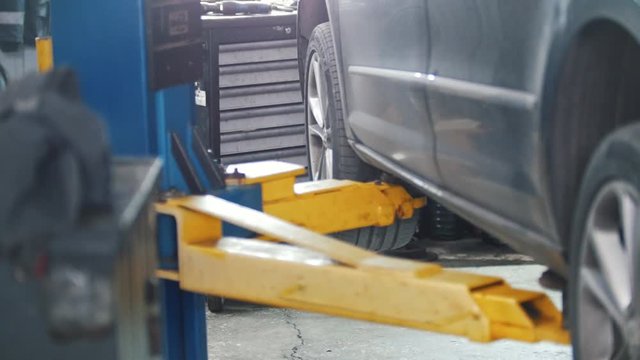 Car lift on a special lift in a workshop