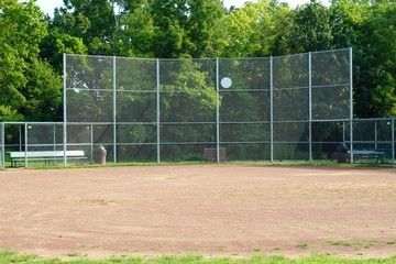 A view of the dirt infield of the baseball field in the park.