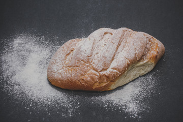 bread on the table just from the stove. Freshly baked bread cooked with flour.