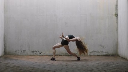 dancing woman attractive young caucasian street dancer performing contemporary moves enjoying modern dance expression practicing in grungy warehouse