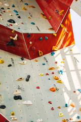 White climbing wall with colorful rocks
