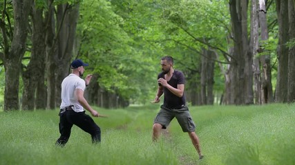 Wooden knives fight between two men outdoors