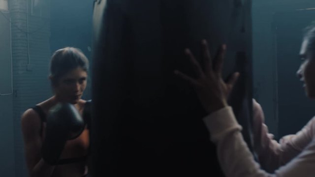 healthy woman athlete training kickboxer coach teaching self defence in boxing workout challenge punching enjoying intense warm up challenge friends practice together in gym
