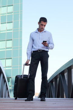 Busines trip concept, Businessman With Travel Luggage and mobile phone