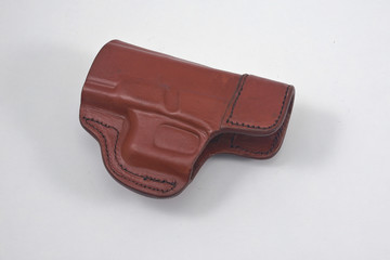 Leather pistol holster on white background