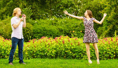 Couple blowing bubbles outdoor