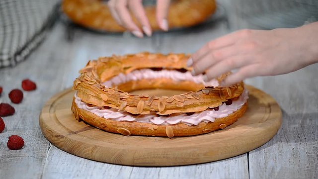 Choux pastry eclair cake Paris Brest with raspberry.