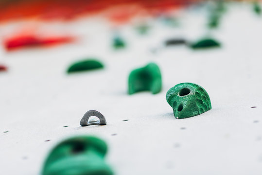 White climbing wall with colorful rocks