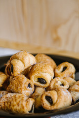 Sweet pastry with poppy seeds in a black plate.