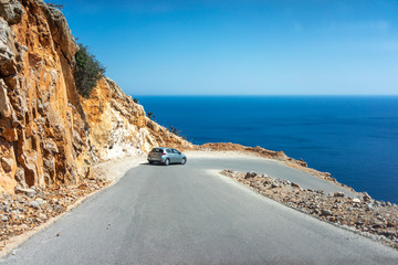 Car on the steep and shallow dangerous mountain road