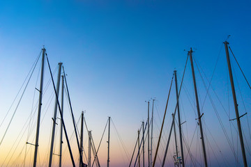 The evening sun and yacht mast silhouette.