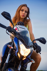Fototapeta na wymiar Portrait of a beautiful girl on a sport motorcycle