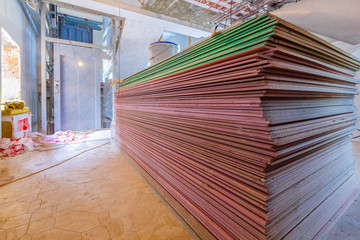 Construction materials and sheets of plasterboard or drywall are prepared for working process of...