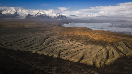 Fototapeta na wymiar Texture of ground terrain and snow mountain on Iceland