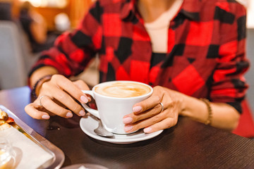 Female hipster with coffee cup closeup