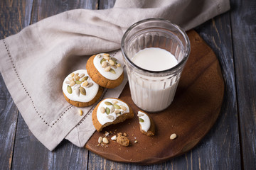 Christmas gingerbread with nuts and seeds with milk on a wooden table. Delicious homemade treat for children and Santa Claus