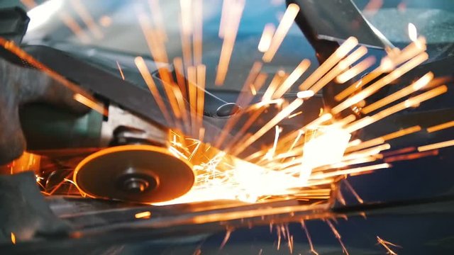 Sparks from welding car parts in a car repair shop