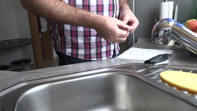 The man is sharpening a kitchen knife