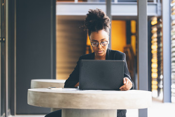 Young businesswoman working on laptop in office