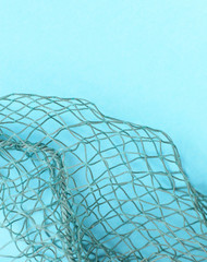 Fishing net with space for your text. Blue background for a fishery theme.
